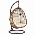 Sillón colgante de ratán sintético con cojín crema y estructura de acero